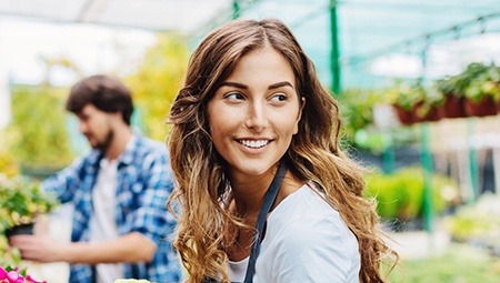 Smiling woman in greehouse