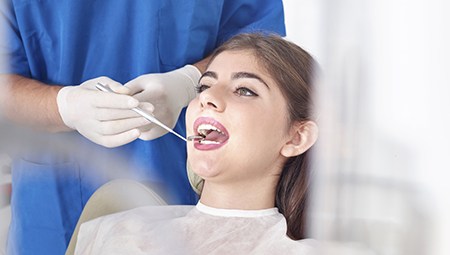 Woman receiving oral cancer screening