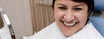 Laughing woman in dental chair